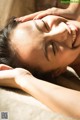 A woman getting a facial massage at a spa.